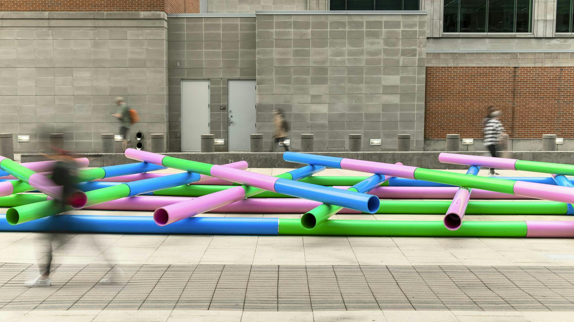 Julia Jamrozik and Coryn Kempster, Pipelines, 2023. Site-specific installation composed of PVC water and wastewater infrastructure pipes. Plaza of the Americas, Denver, Colorado. Presented by the Biennial of the Americas with artistic direction by Black Cube Nomadic Art Museum. Courtesy the artists and Black Cube. Photo: Third Dune Productions.