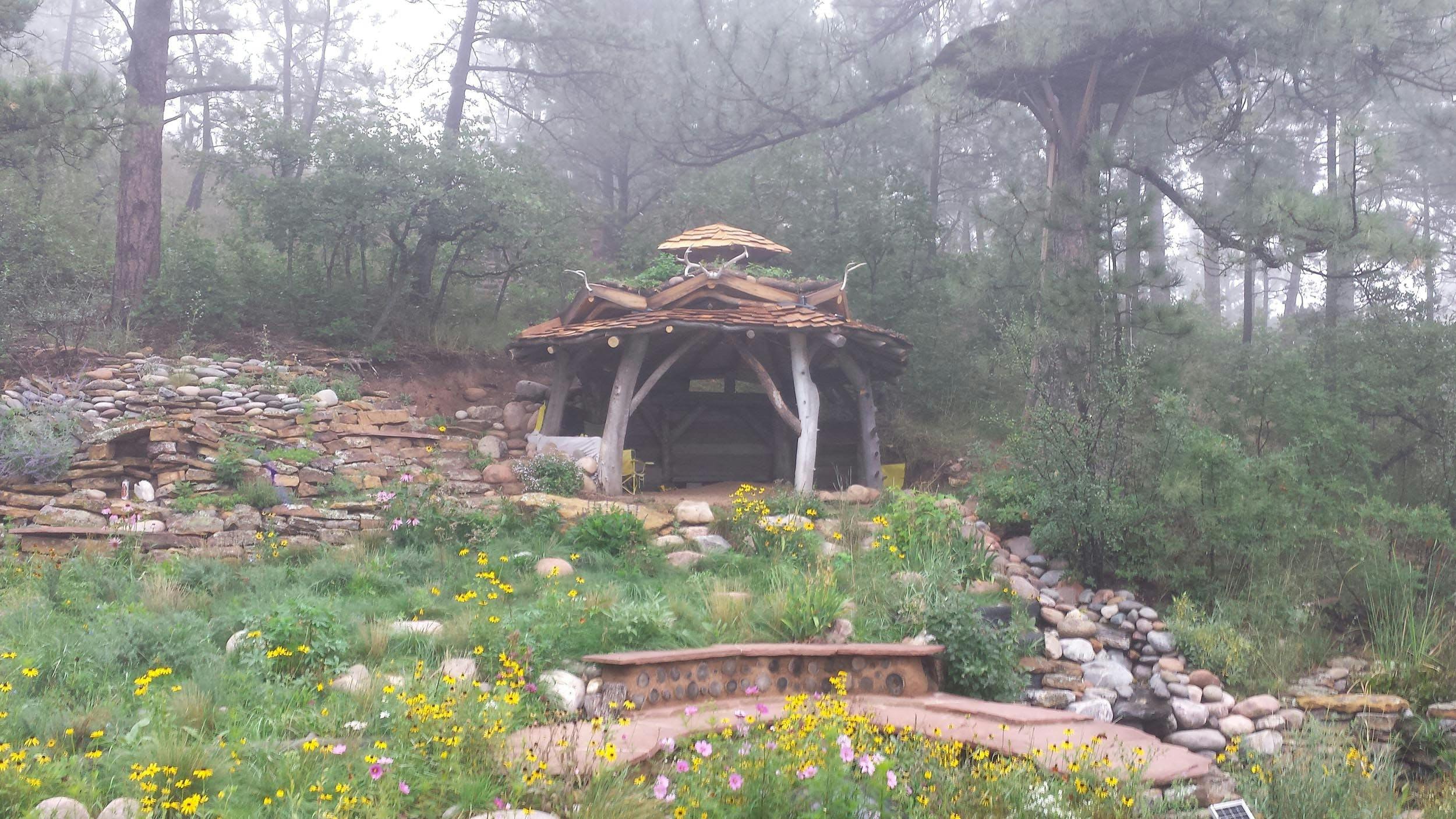 YESRAD, Center for Radical Positivity, 2011 (ongoing), wood, stone, perennials, water, fish, 12' x 14' x 14'